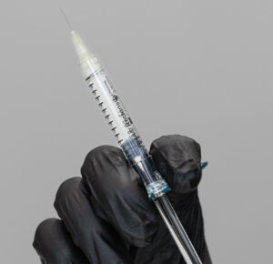 A gloved provider prepares an injection of filler for wrinkles in Chapel Hill